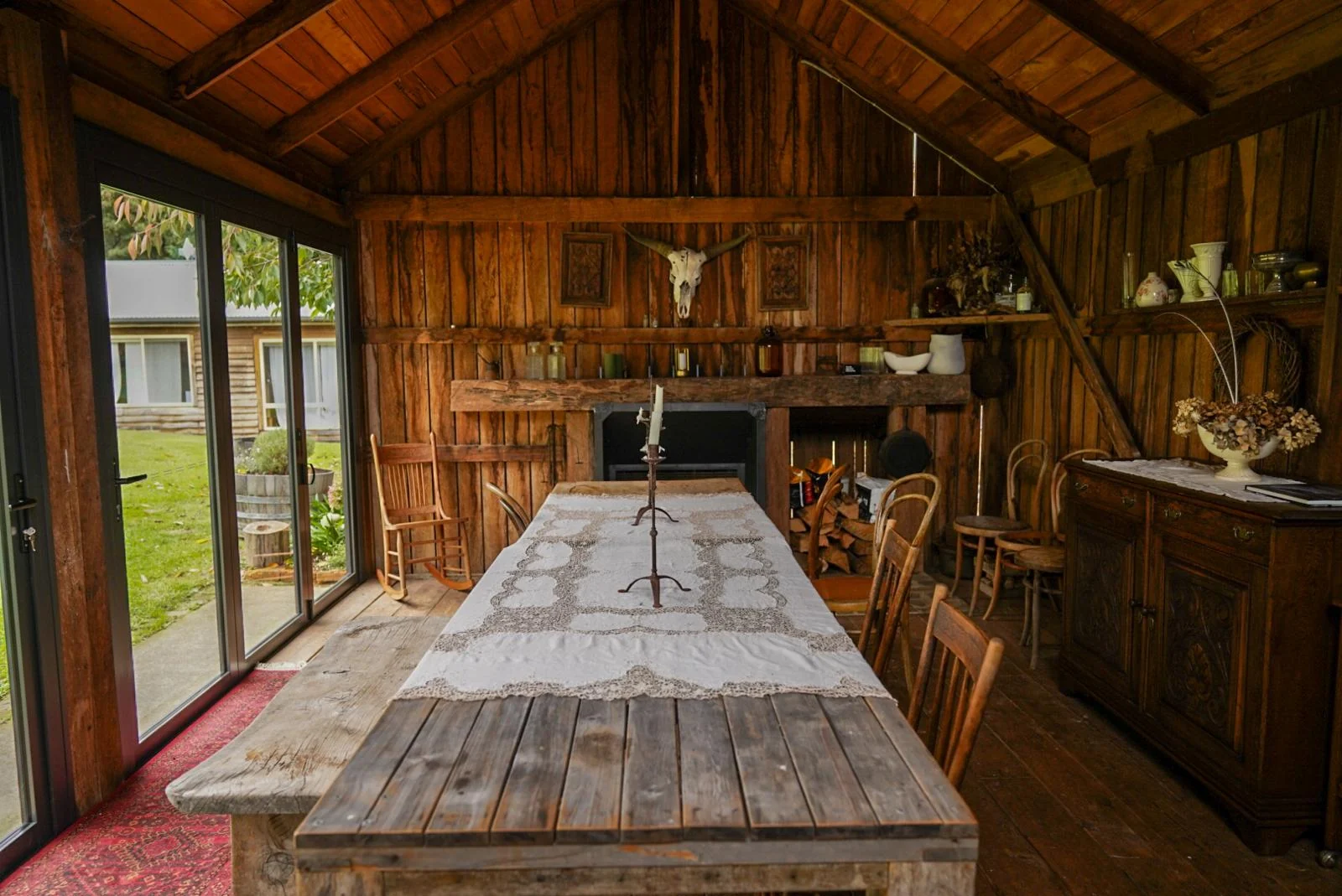 A long timber table in the rustic gathering room