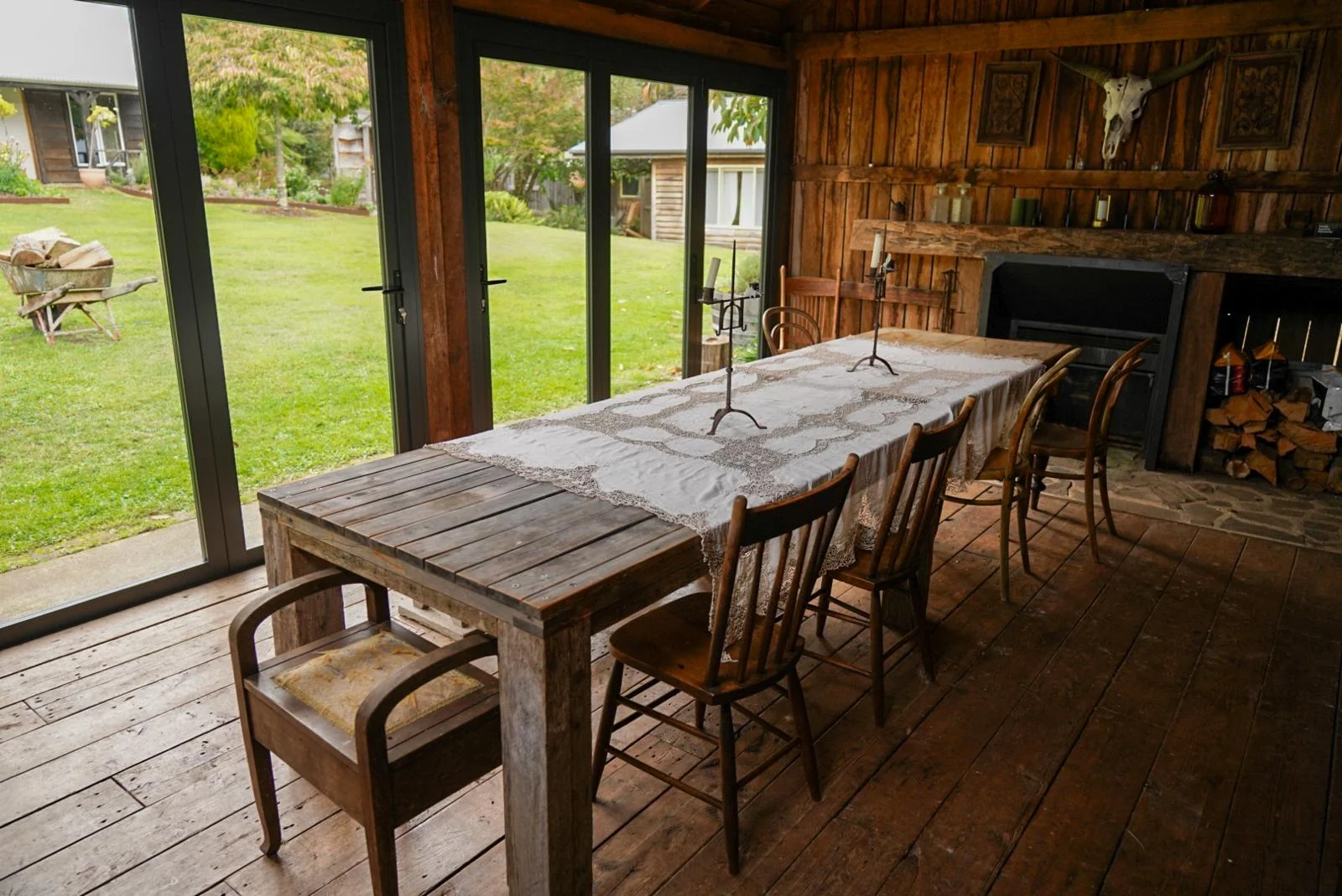 A long celebration table set inside the rustic barn