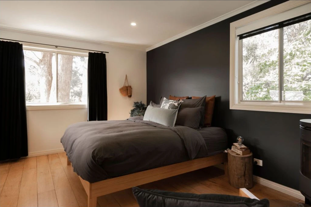 A peaceful cottage bedroom overlooking the trees at Whispering Woods