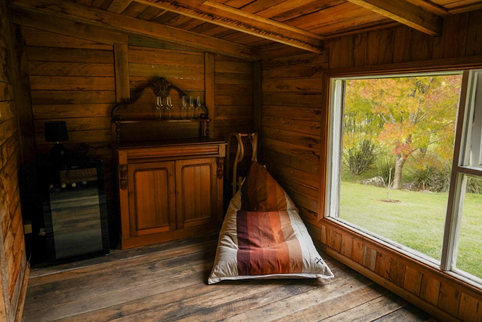 A daybed beneath cottage windows